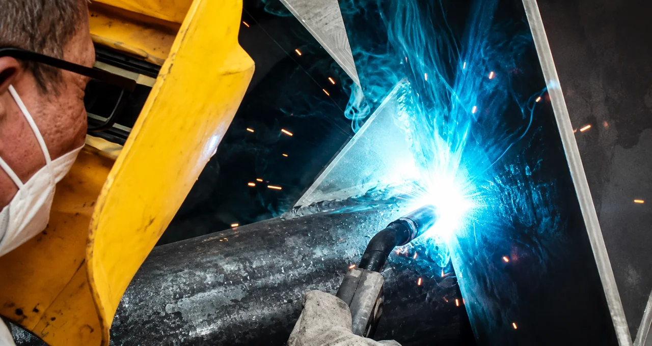 Close-up welding during metal sculpture assembly