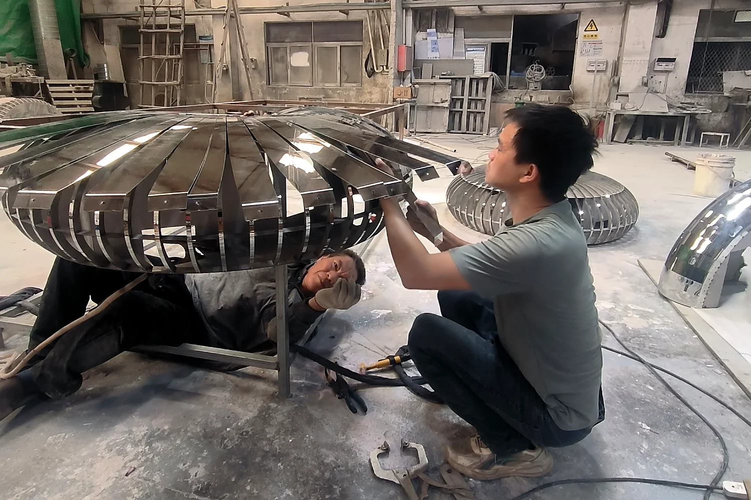 ASEN craftsmen fabricating a custom stainless steel sculpture structure in the workshop